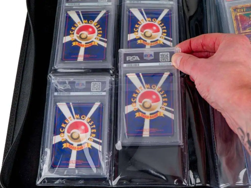 Hand placing PSA graded card into binder pocket