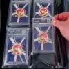 Hand placing PSA graded card into binder pocket